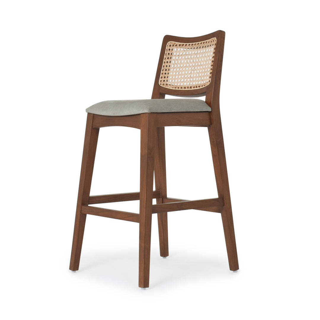 The Riviera Cane Bar Stool placed at a kitchen counter
