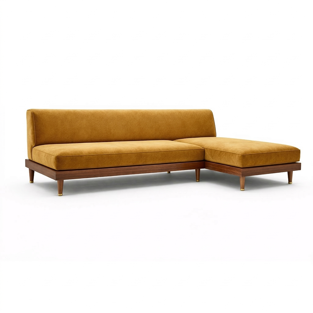 A contemporary modular sectional sofa featuring vibrant mustard yellow velvet upholstery, a right-hand chaise lounge, a solid dark walnut wood base, and tapered legs with distinct brass end caps, isolated on a clean white studio background.